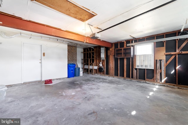 garage featuring electric panel and a garage door opener