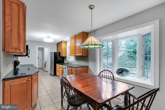 dining area with light tile patterned flooring and washer / dryer