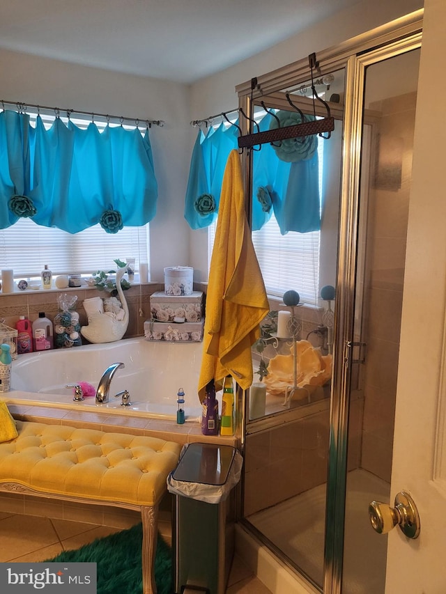 full bathroom with tile patterned flooring, a shower stall, and a bath