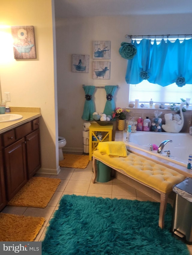 full bathroom with vanity, tile patterned floors, toilet, and a tub