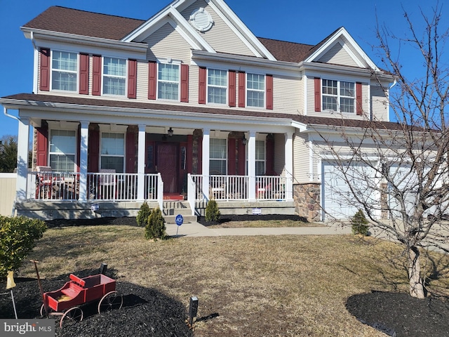 view of front facade with covered porch and an attached garage