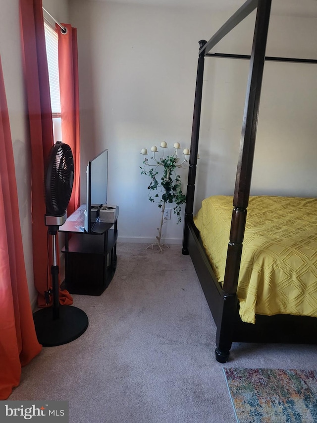 bedroom with carpet flooring and baseboards