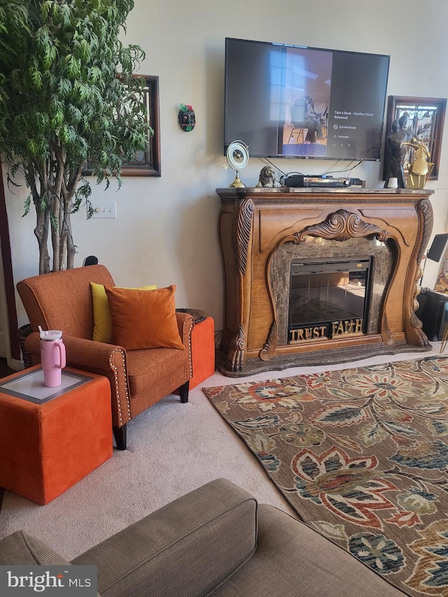 living room with carpet flooring and a glass covered fireplace