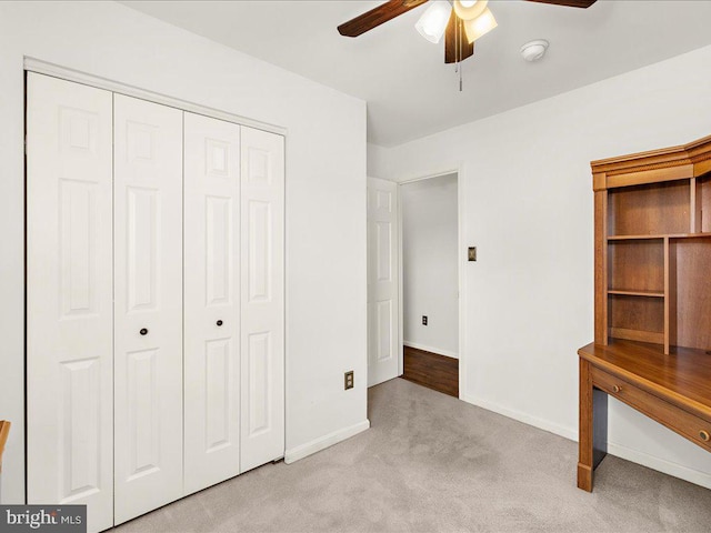 unfurnished bedroom with a closet, a ceiling fan, baseboards, and carpet floors