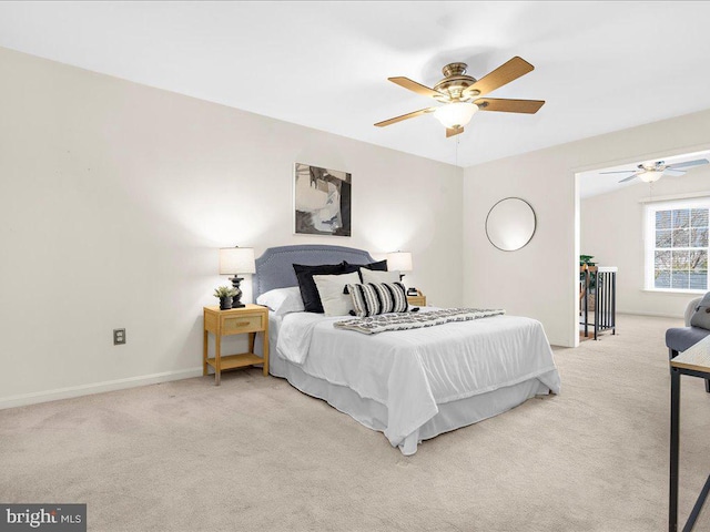 carpeted bedroom featuring baseboards and a ceiling fan