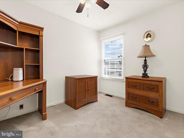 office with baseboards, light colored carpet, visible vents, and ceiling fan