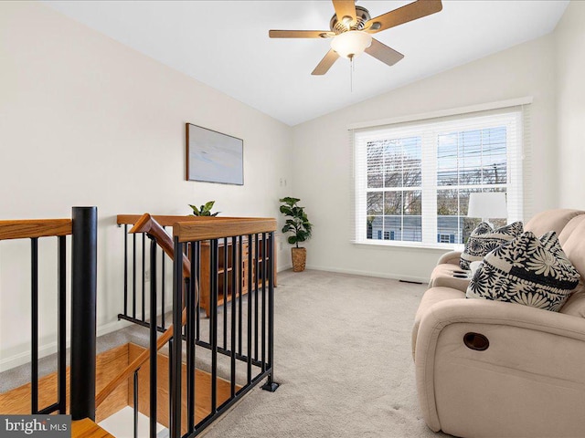 interior space featuring baseboards, visible vents, lofted ceiling, ceiling fan, and light colored carpet