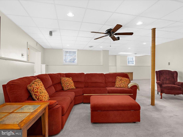 carpeted living area featuring recessed lighting and a drop ceiling