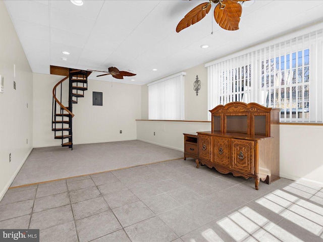 living room featuring baseboards, ceiling fan, stairway, electric panel, and recessed lighting