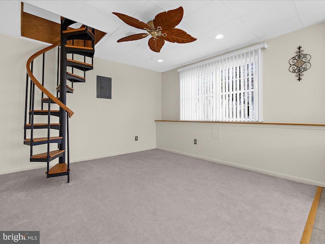 spare room featuring baseboards, electric panel, recessed lighting, stairs, and carpet flooring