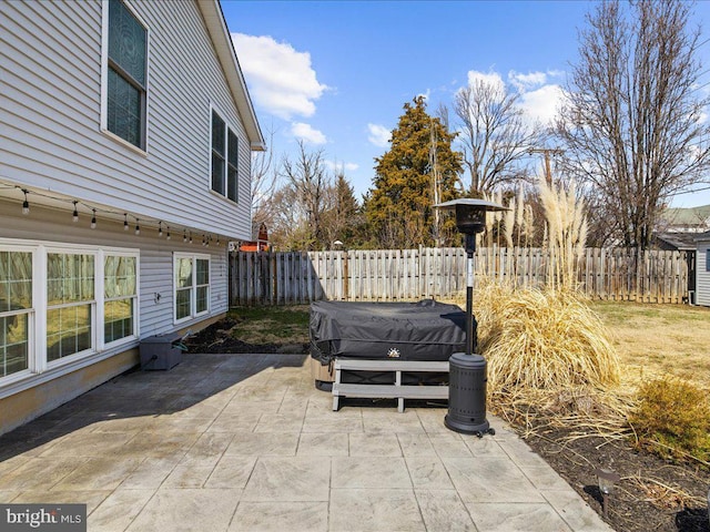 view of patio / terrace featuring fence and a hot tub