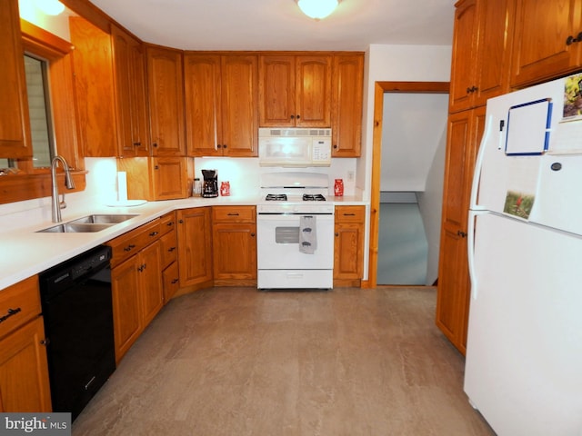 kitchen with white appliances, light countertops, a sink, and brown cabinetry