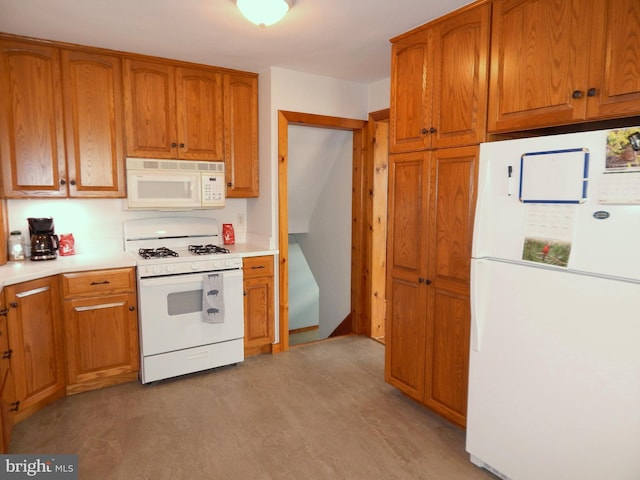 kitchen featuring light countertops, white appliances, and brown cabinetry