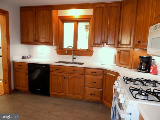 kitchen featuring brown cabinetry, white appliances, and a sink