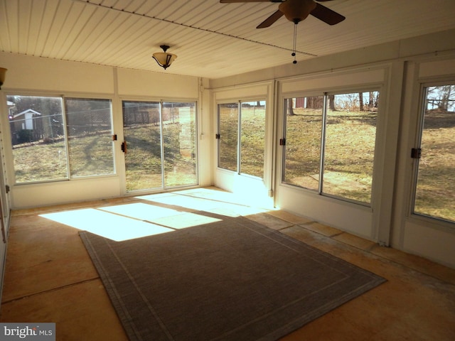 unfurnished sunroom with a ceiling fan