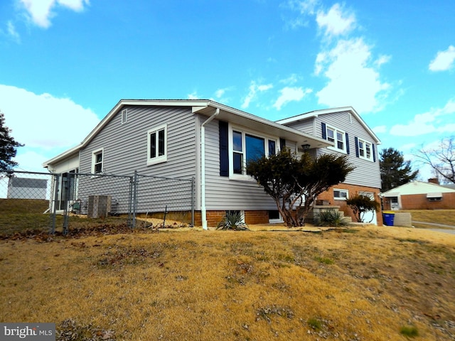 view of side of home featuring a yard and fence