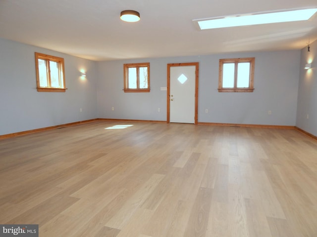 interior space with light wood-style flooring and baseboards