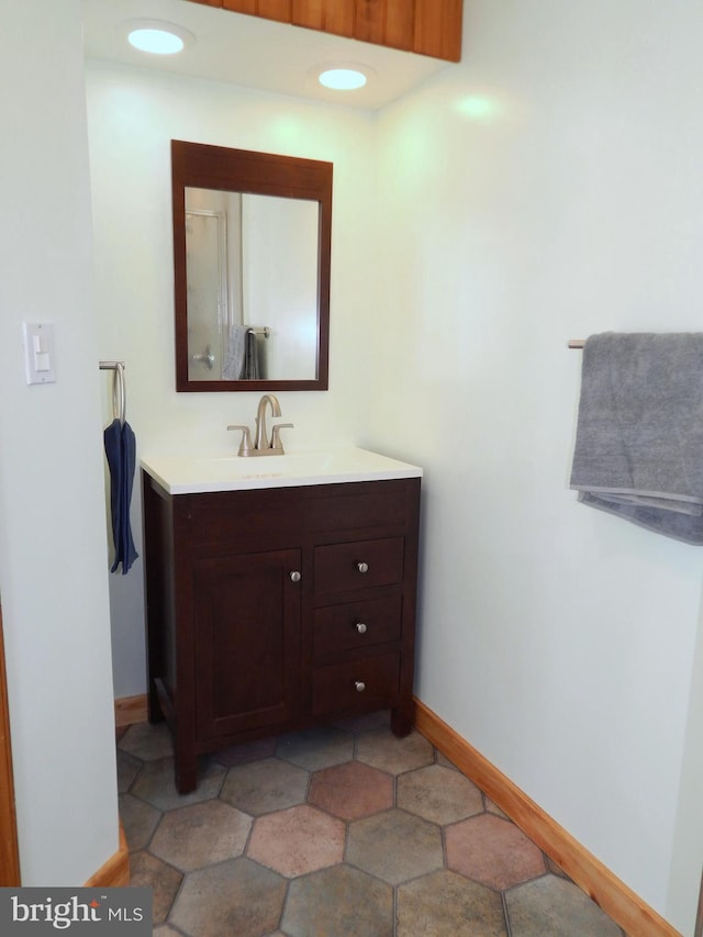 bathroom with vanity and baseboards