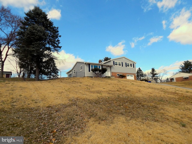 view of front of house featuring a chimney and an attached garage