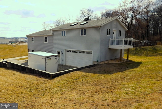 back of property with an attached garage and a yard