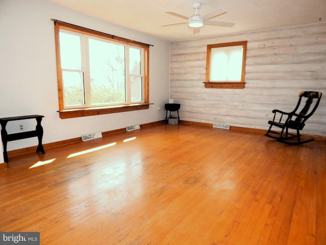 unfurnished room featuring light wood finished floors and visible vents