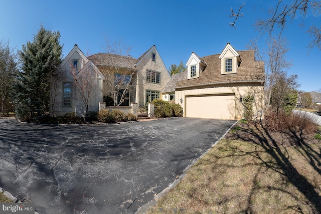 view of front of property with an attached garage and aphalt driveway