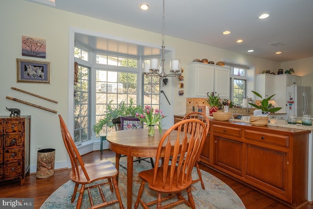 dining room with dark wood-style floors, a baseboard heating unit, baseboards, and recessed lighting