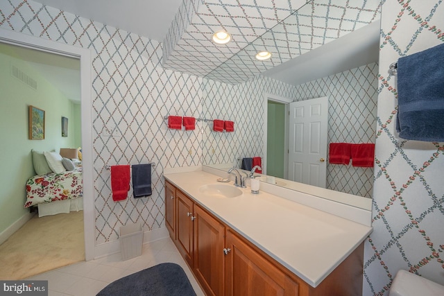 bathroom featuring tile patterned floors, vanity, and wallpapered walls