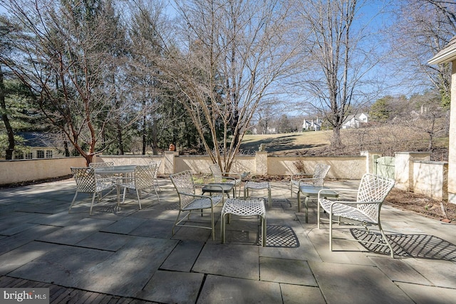 view of patio featuring outdoor dining area and fence