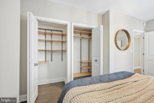 bedroom with a closet, baseboards, and wood finished floors