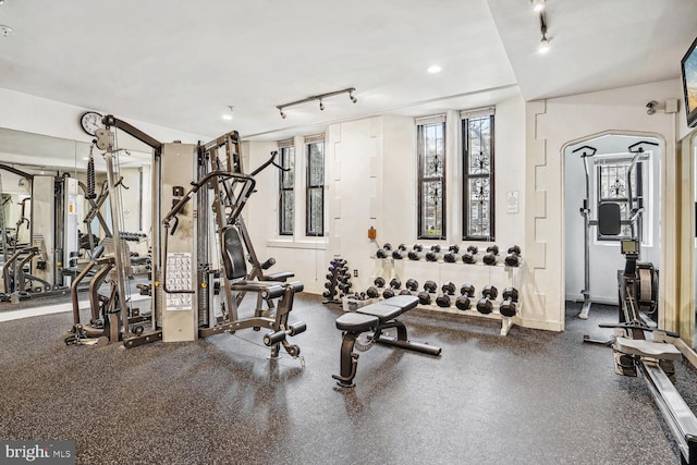 workout area with rail lighting and recessed lighting