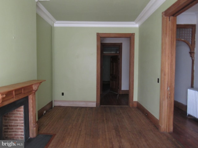 unfurnished living room with radiator, baseboards, crown molding, and wood finished floors