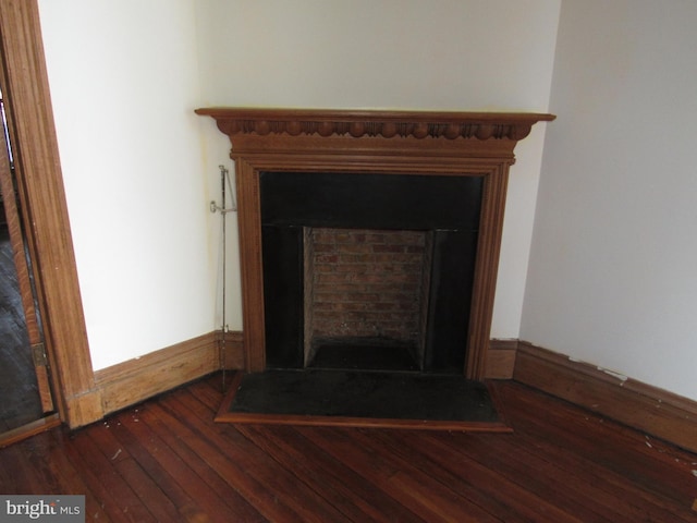 interior details featuring a fireplace and wood finished floors