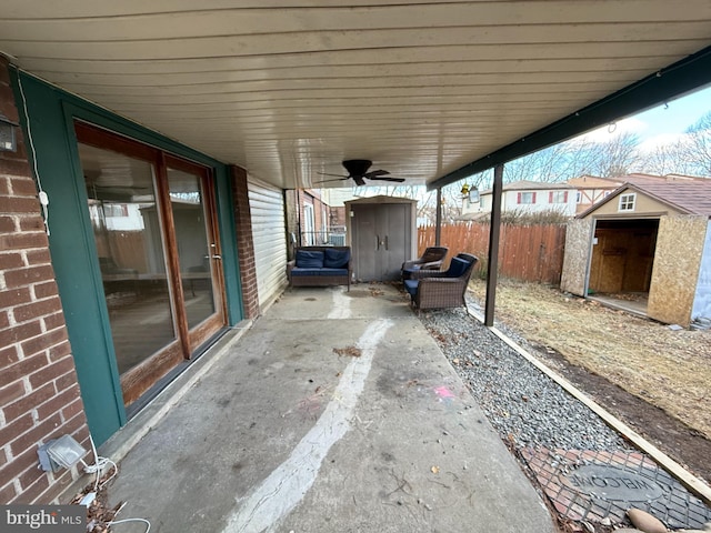 view of patio featuring a shed, fence, and an outdoor structure