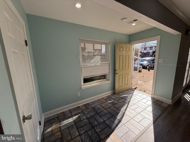 entryway featuring brick floor, recessed lighting, visible vents, and baseboards