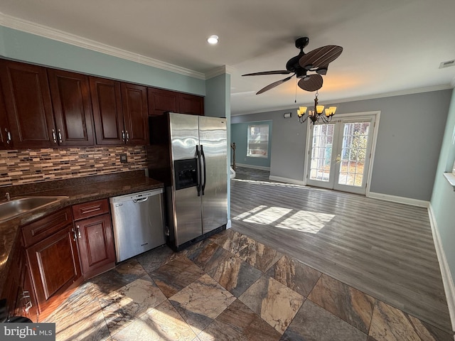 kitchen featuring baseboards, decorative backsplash, dark countertops, stainless steel appliances, and crown molding