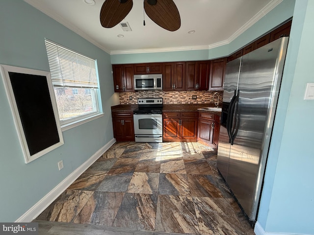 kitchen with stainless steel appliances, dark countertops, visible vents, decorative backsplash, and a sink