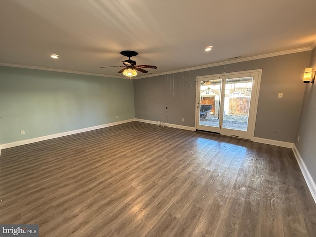 spare room with crown molding, baseboards, ceiling fan, and dark wood-style flooring