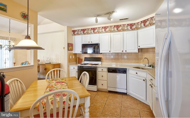 kitchen featuring light countertops, white appliances, white cabinets, and a sink