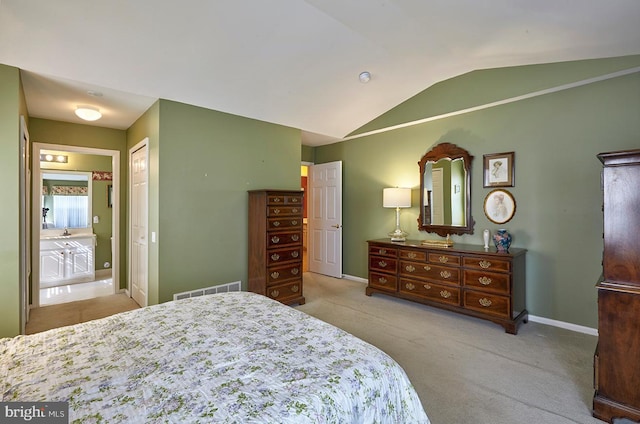 carpeted bedroom with lofted ceiling, a closet, visible vents, and baseboards