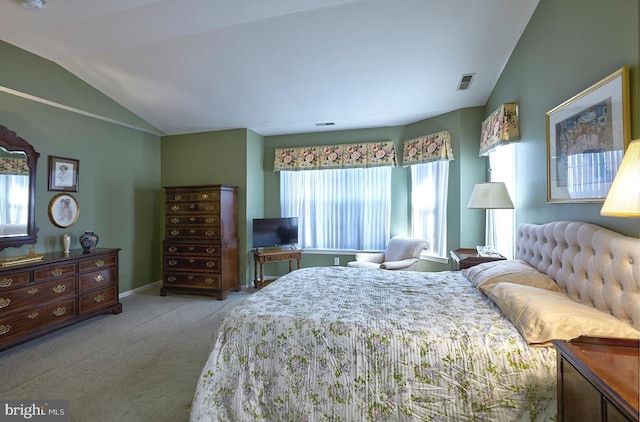 carpeted bedroom with baseboards, visible vents, and vaulted ceiling