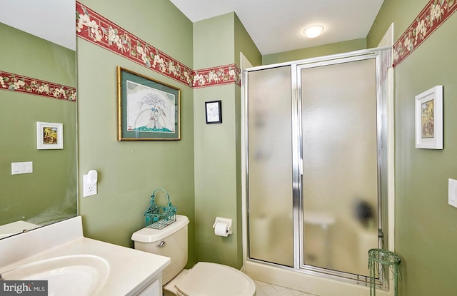 bathroom featuring toilet, a shower stall, and vanity