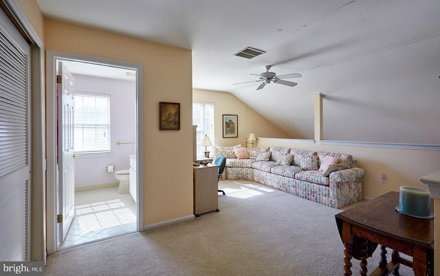 carpeted living room featuring vaulted ceiling, ceiling fan, plenty of natural light, and visible vents