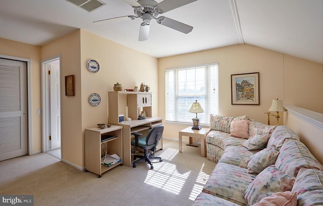 home office featuring light carpet, visible vents, baseboards, lofted ceiling, and ceiling fan