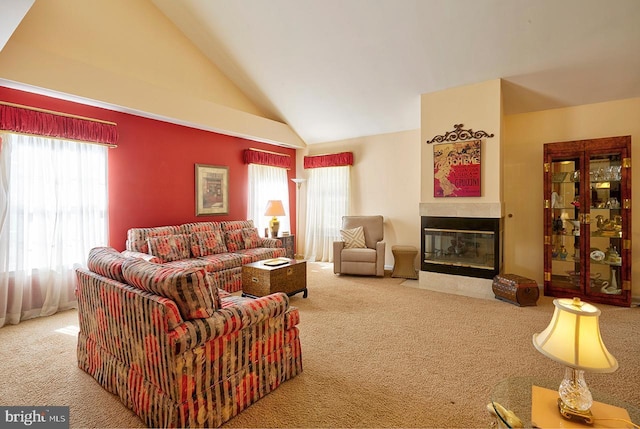 living room with carpet floors, high vaulted ceiling, and a multi sided fireplace