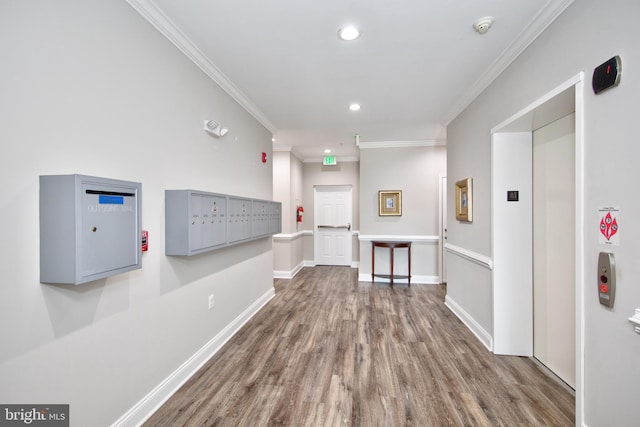 hallway featuring crown molding, recessed lighting, mail area, wood finished floors, and baseboards