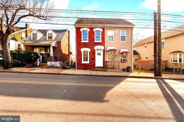 townhome / multi-family property with cooling unit and fence