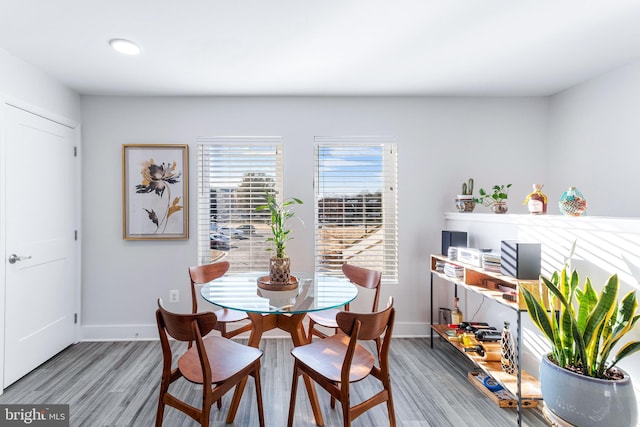 dining area featuring baseboards and wood finished floors