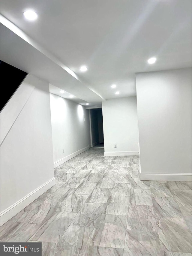 finished basement featuring marble finish floor, recessed lighting, and baseboards