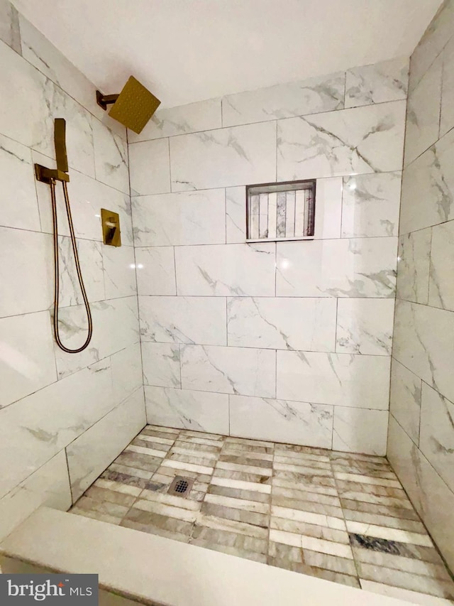 bathroom with tiled shower